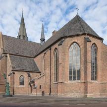 a large brick church with a steeple on a street
