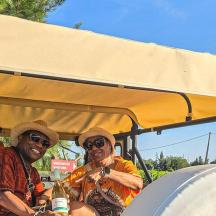 two men sitting in the back of a golf cart