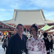 a man and a woman standing in front of a building