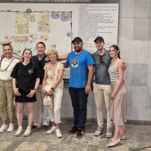 a group of people standing in front of a wall