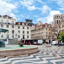 a fountain in the middle of a city with buildings