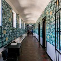 a hallway in a building with pictures on the walls