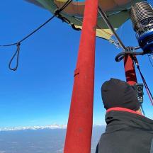 a person is looking at the mountains from a helicopter