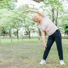 a man in a park throwing a frisbee