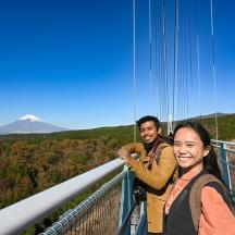 two people standing on a viewing deck of a mountain