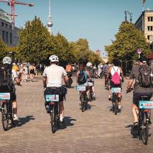 a group of people riding bikes down a street