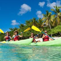 a group of people riding in kayaks in the ocean