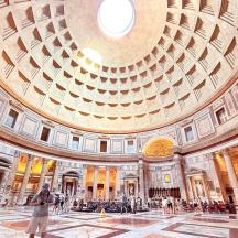 a large building with a domed ceiling with people in it
