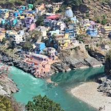a village on a hill next to a river