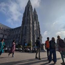 a group of people standing in front of a cathedral