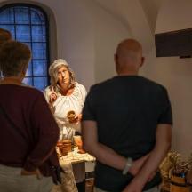 a group of people standing around a woman in a room