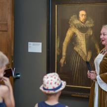 a group of people standing in front of a painting