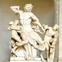 a statue of a man with three men around him
