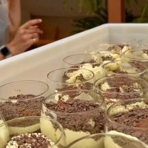 a tray of glasses filled with desserts on a table