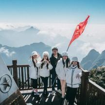 a group of people standing on top of a mountain