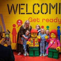 a woman taking a picture of a group of lego people