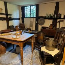 a kitchen with a table and some pots and pans