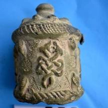 a pottery jar with a snake on the side