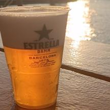 a glass of beer sitting on a table