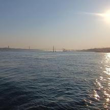 a large body of water with a bridge in the background