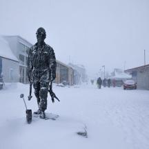 a statue of a man standing in the snow