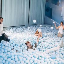 a group of people playing in an inflatable ball pit