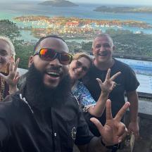 a group of people giving the peace sign with their hands