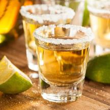 a table with three glasses of beer and a lime