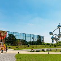 a large glass building with people walking in front of it