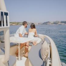 a man and woman sitting on the back of a boat