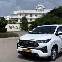 a white car parked in front of a building