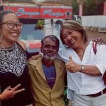 two women and a man posing for a picture