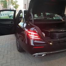 a black car with its door open on a street