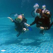 two people in the water in a swimming pool