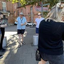 a group of people standing on a sidewalk