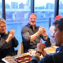 a group of people sitting around a table eating food