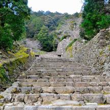 a set of stone stairs in a stone wall