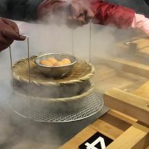 a man cooking a cake with a bowl of eggs