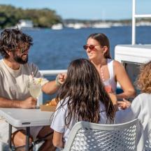 a group of people sitting at a table on a boat