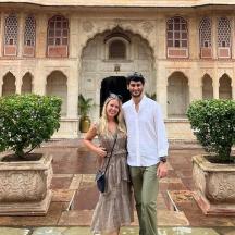a man and a woman standing in front of a building