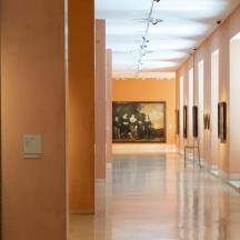 a hallway of an art gallery with paintings