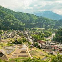 a town in a valley with mountains in the background