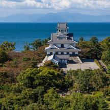 a building on top of a hill near the ocean