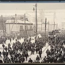 an old photo of a crowd of people on a street