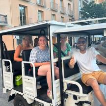 a group of people riding in a golf cart