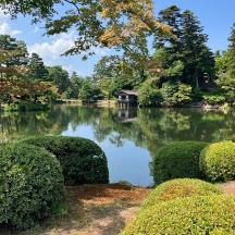 a pond with a house in the middle of it
