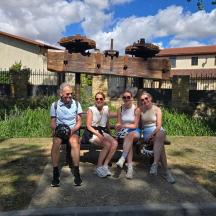 a group of people sitting on a bench in a yard
