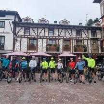 a group of people on bikes in front of a building