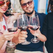 a group of people holding up wine glasses