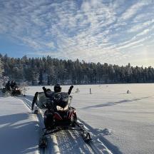 a snowmobile is driving through a snow covered field